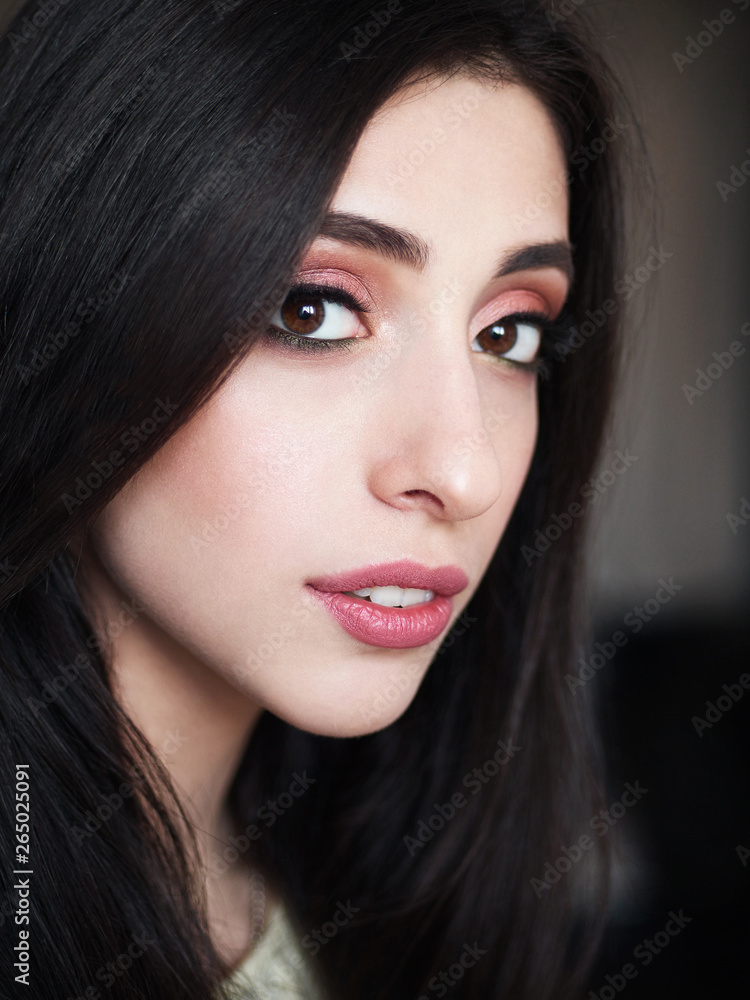Close up portrait of young beautiful smiling woman with gorgeous long black hair and trendy high end makeup vintage film color tone. Beauty cosmetics and skin care concept. Close up portrait of young beautiful smiling woman with gorgeous long black hair and trendy high end makeup vintage film color tone. Beauty cosmetics and skin care concept.