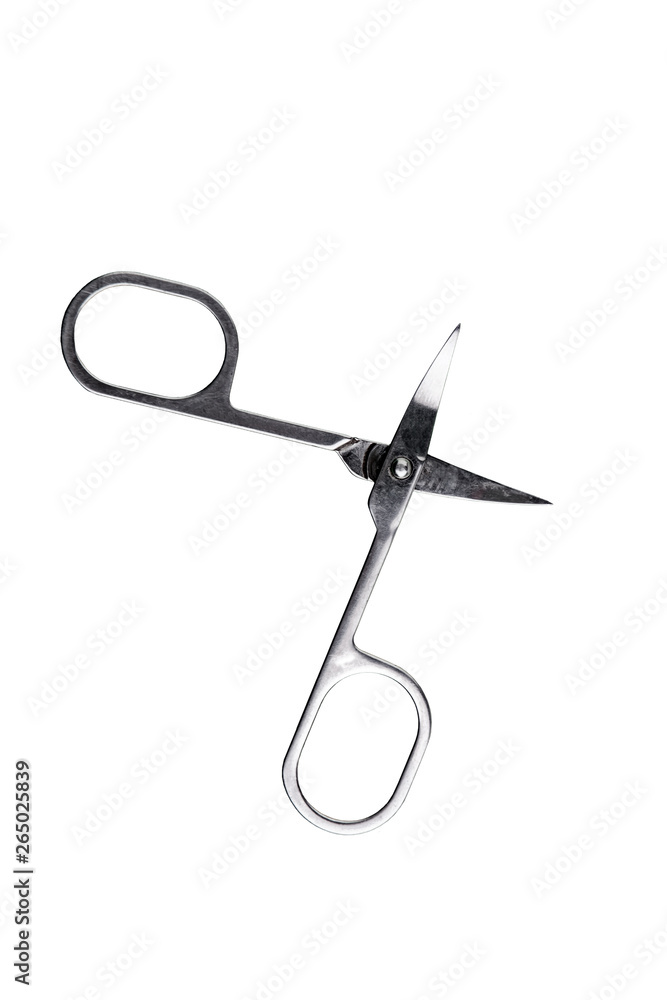 Hand care tool - small shiny stainless steel manicure scissors, isolated on white background, close, short focus