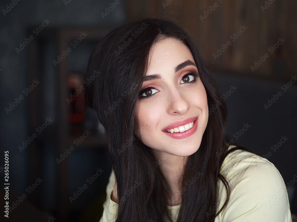 Portrait of young beautiful smiling woman enjoying weekend free time in cozy coffee shop cafe vintage film color tone. City lifestyle concept. Portrait of young beautiful smiling woman enjoying weekend free time in cozy coffee shop cafe vintage film color tone. City lifestyle concept.