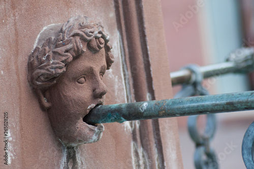 Closeup of stoned head in fountain in Mulhouse - France