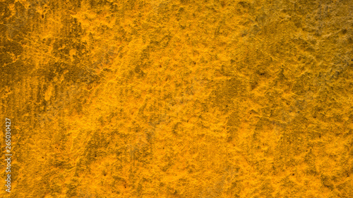 Golden stone surface texture. Natural background in gold color. Texture of stone wall in retro style. Widescreen