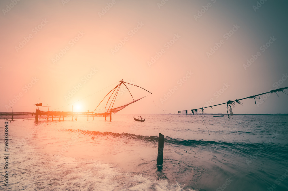 Fototapeta premium Fishing nets silhouette at sunset. Cochin, South India, Kerala