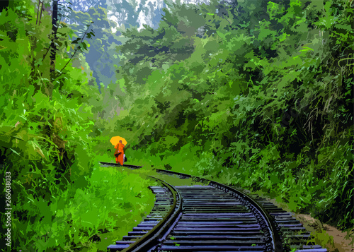 A monk walks the rail way line in a jungle. 