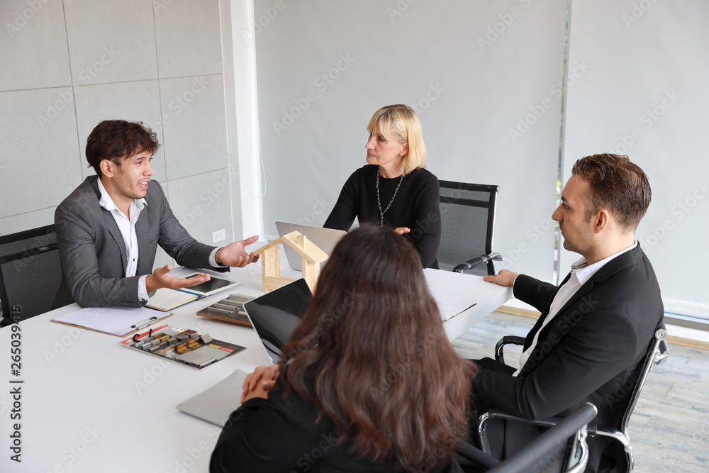 Multiethnic business people discussing company about new house project in meeting room with smiling and happy faces Multiethnic business people discussing company about new house project in meeting room with smiling and happy faces