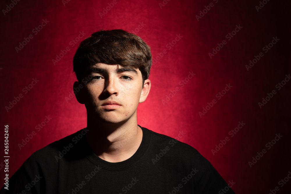 Fototapeta premium Young man portrait on a red background