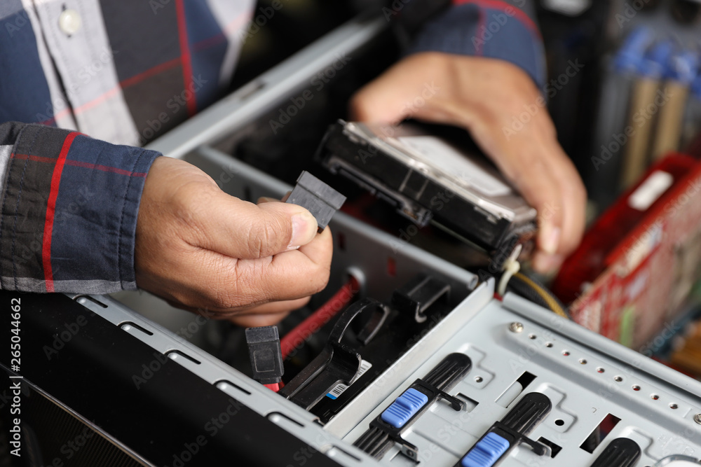 technician man fix or upgrading hard disk by unplug or plug cable on computer technician man fix or upgrading hard disk by unplug or plug cable on computer