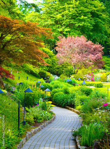 Brick path meandering thorugh a colorful blooming section of Butchart Gardens, Victoria Island photo