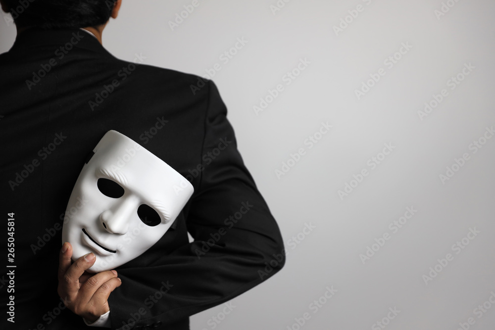politician or businessman wearing black suit and white mask Photo | Adobe Stock