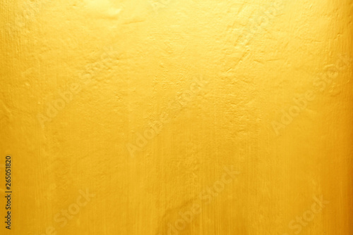 Old Grunge Golden Painting on Wood Wall Background with Light Leak on Top.