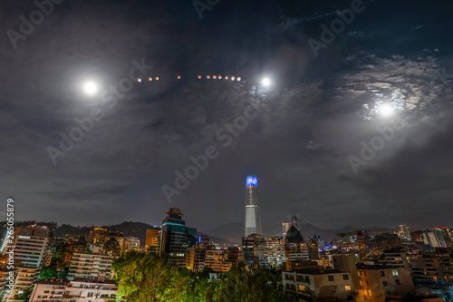 Red blood Moon eclipse from Santiago de Chile city, a view from the southern hemisphere of this amazing astronomical event of the Earth shadow crossing the Moon surface over Santiago skyline, awe view