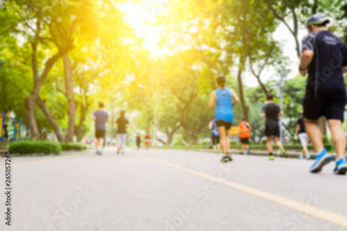 Blurred background of people running at park outdoor.