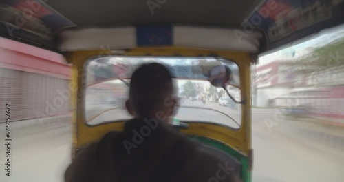 Tourist zooming in busy streets of Varanasi sitting inside auto rickshaw