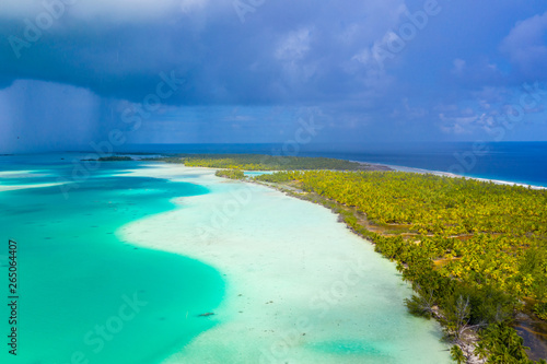French Polynesia Tahiti aerial drone view of Fakarava atoll and famous Blue Lagoon and motu island with perfect beach, coral reef and Pacific Ocean. Tropical travel paradise in Tuamotus Islands.