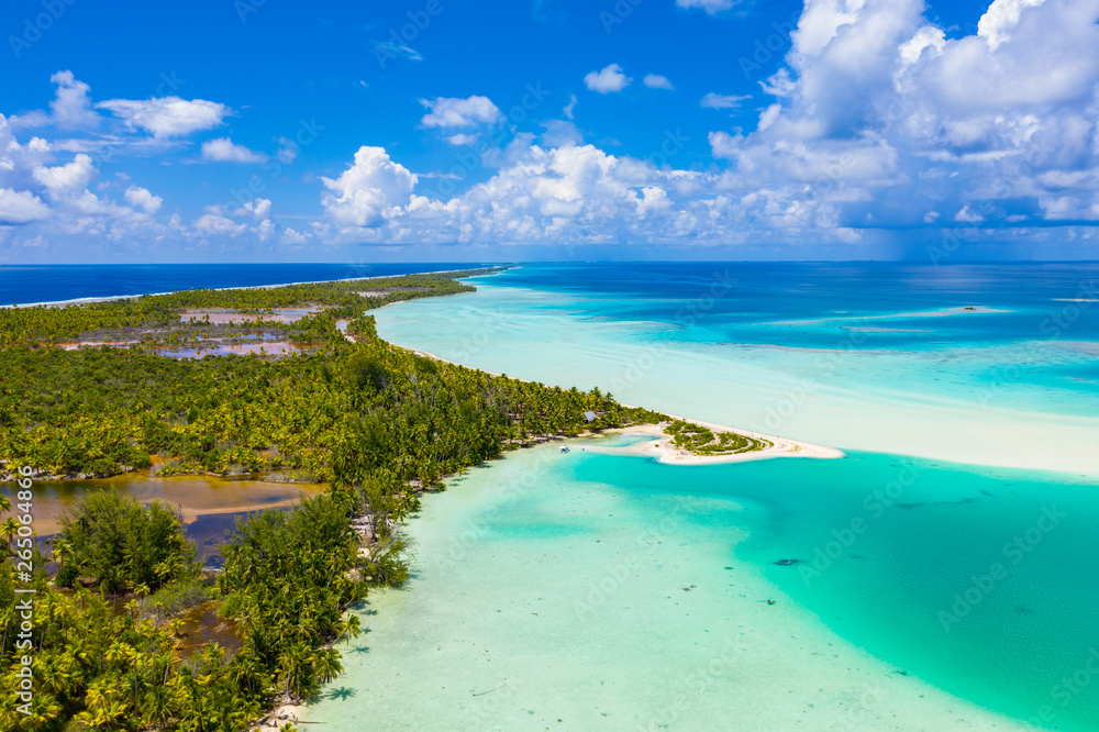 Drone aerial video of Fakarava atoll island motu Blue Lagoon, Teahatea and UNESCO Biosphere Reserve French Polynesia Tahiti, coral reef and Pacific Ocean. Tropical travel paradise in Tuamotus Islands.
