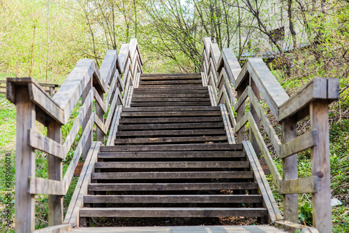 Old wooden staircase with railings stretching away