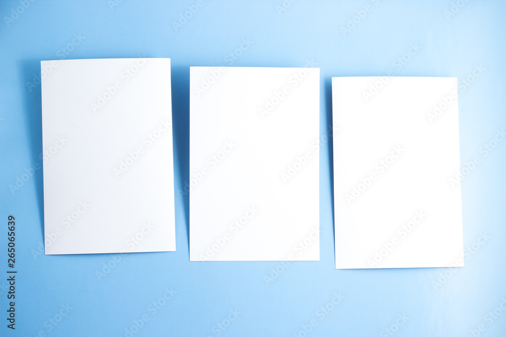 Three blanks white postcards / flyers / invitations mock-up on blue background Three blanks white postcards / flyers / invitations mock-up on blue background