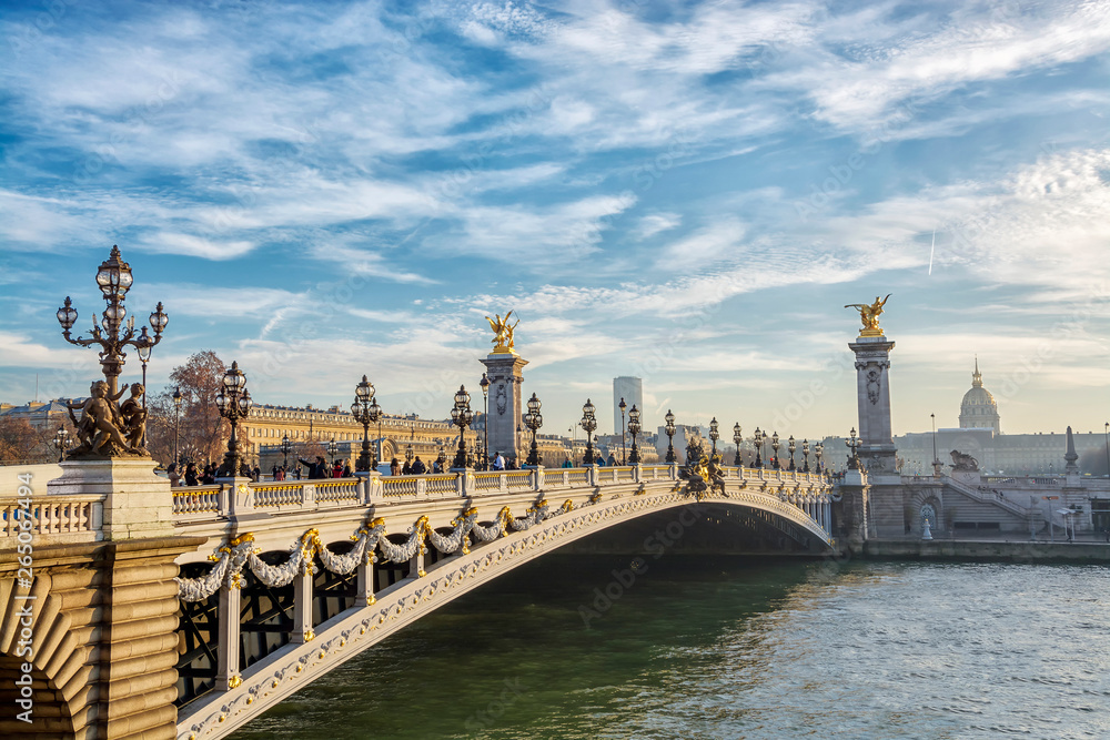 View on the  Bridge of Alexandre III and and Les Invalides across Seine River in Paris at evening, France.