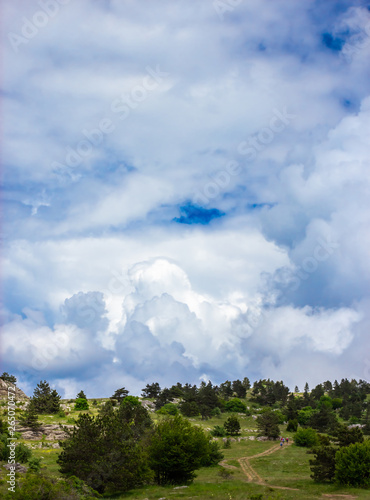 Colorful summer landscape in the Crimean mountains, under a blue sky with white clouds
