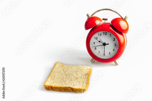 Red alarm clock with toast bread