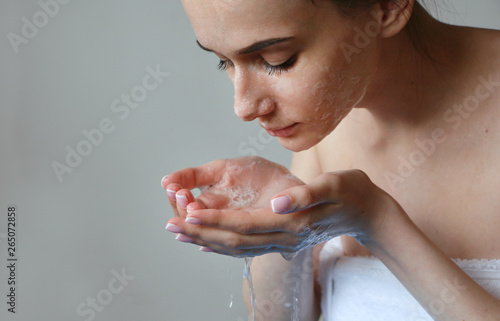 girl cleans face before bed