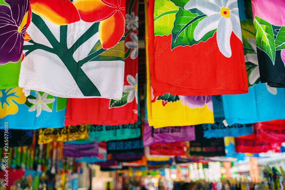 Sarong skirts shop at city market of Papeete, Tahiti, French Polynesia.  Colorful clothing pareo wrap hanging for sale as handmade tourism souvenir.  Stock-Foto | Adobe Stock