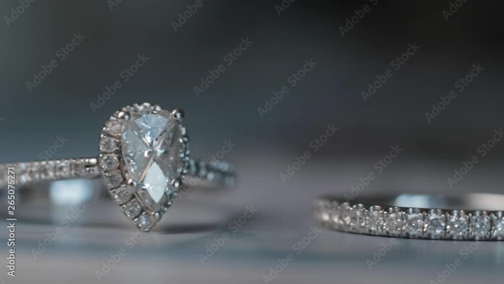 Macro Shot of a diamond Wedding and Engagement Ring on a blue background Macro Shot of a diamond Wedding and Engagement Ring on a blue background