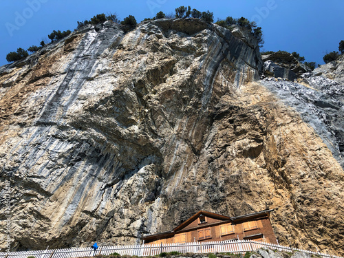 Hiking and Äscher cliff restaurant (Ascher or Aescher cliff restaurant), Berggasthaus Aescher -  Wildkirchli or Mountain inn Aescher-Wildkirchli below Ebenalp - Canton of Appenzell (AI), Switzerland photo