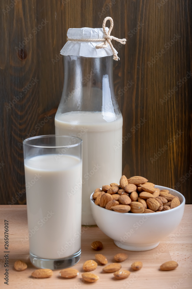 Glass of Milk Almond milk and organic almonds on wooden background, Alternative Milk. Nuts milk Glass of Milk Almond milk and organic almonds on wooden background, Alternative Milk. Nuts milk