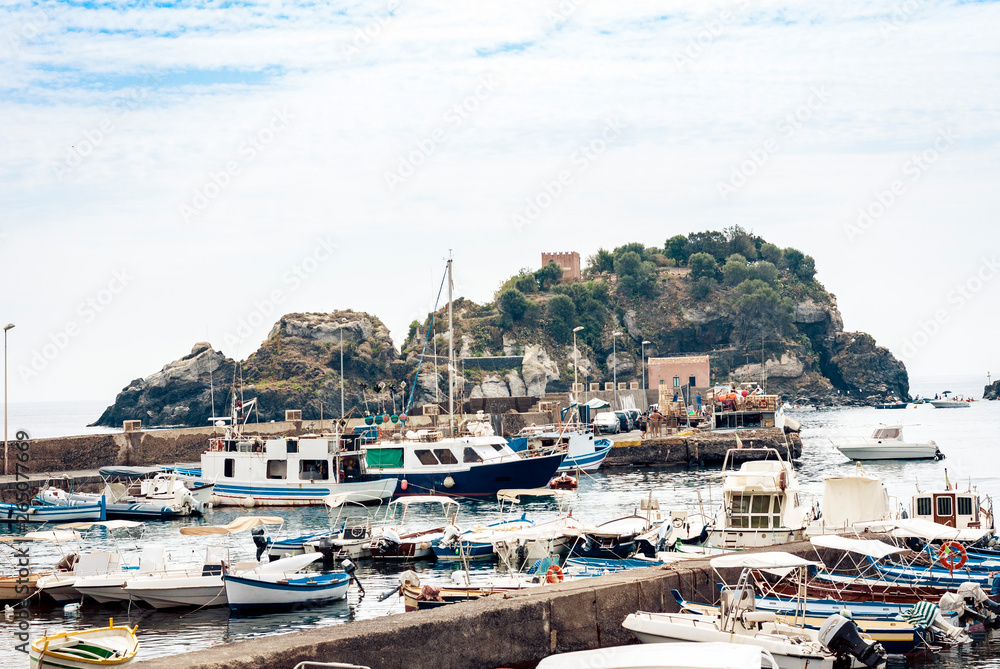 Acitrezza harbor with fisher boats next to Cyclops islands, Catania, Sicily, Italy.