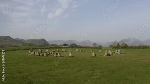 Castlerigg Stone Circle aerial parallax low perspective drone shot during the magic hour after Sunrise photo