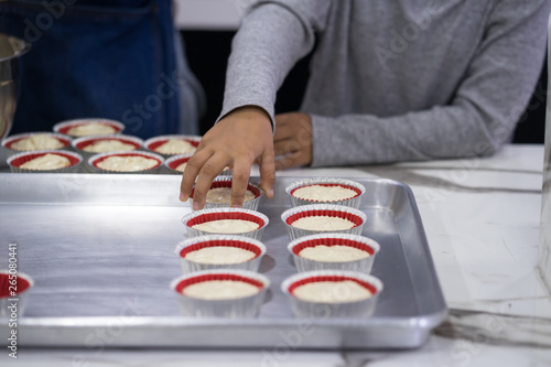 hand of asia kid boy making a cake