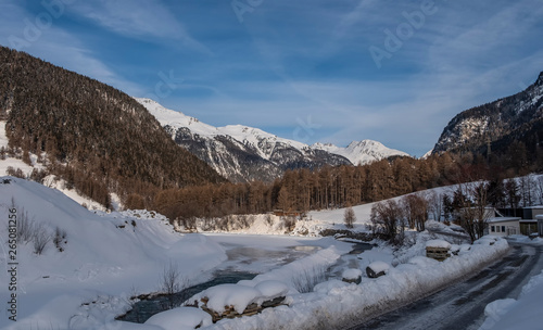 Winter landscape with mountains and river Inn in the Engadine valley in a sunny morning, Zernez, Lower Engadine, Graubunden, Switzerland.