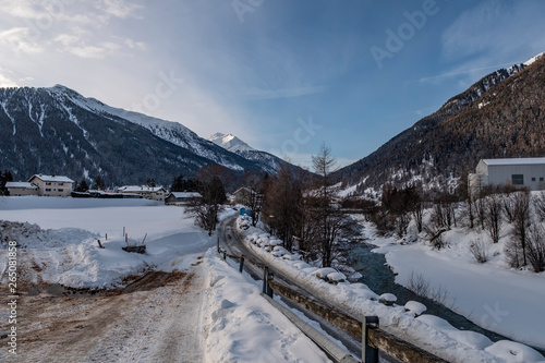 Winter landscape with mountains and river Inn in the Engadine valley in a sunny morning, Zernez, Lower Engadine, Graubunden, Switzerland.