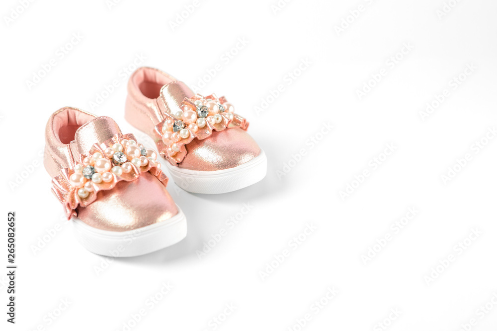 the pink children's sneakers isolated on a white background the pink children's sneakers isolated on a white background