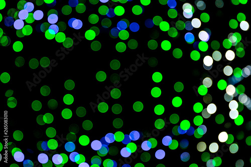 Unfocused abstract colourful bokeh on black background. defocused and blurred many round light © sosiukin