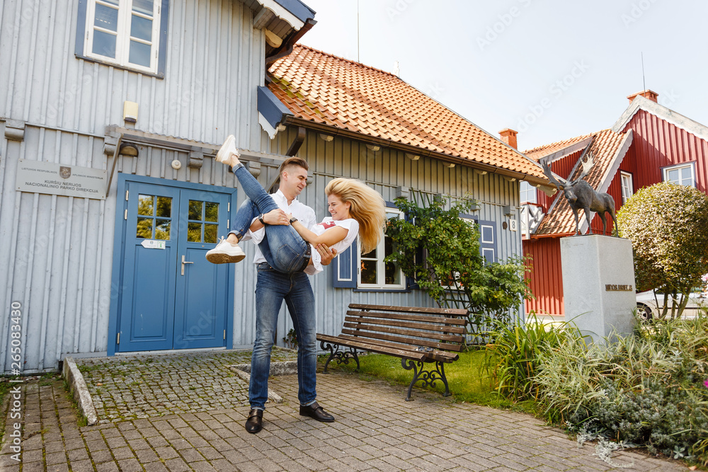 beautiful blonde and her boyfriend have a good time in the village in summer. Couple in love resting in Nida beautiful blonde and her boyfriend have a good time in the village in summer. Couple in love resting in Nida