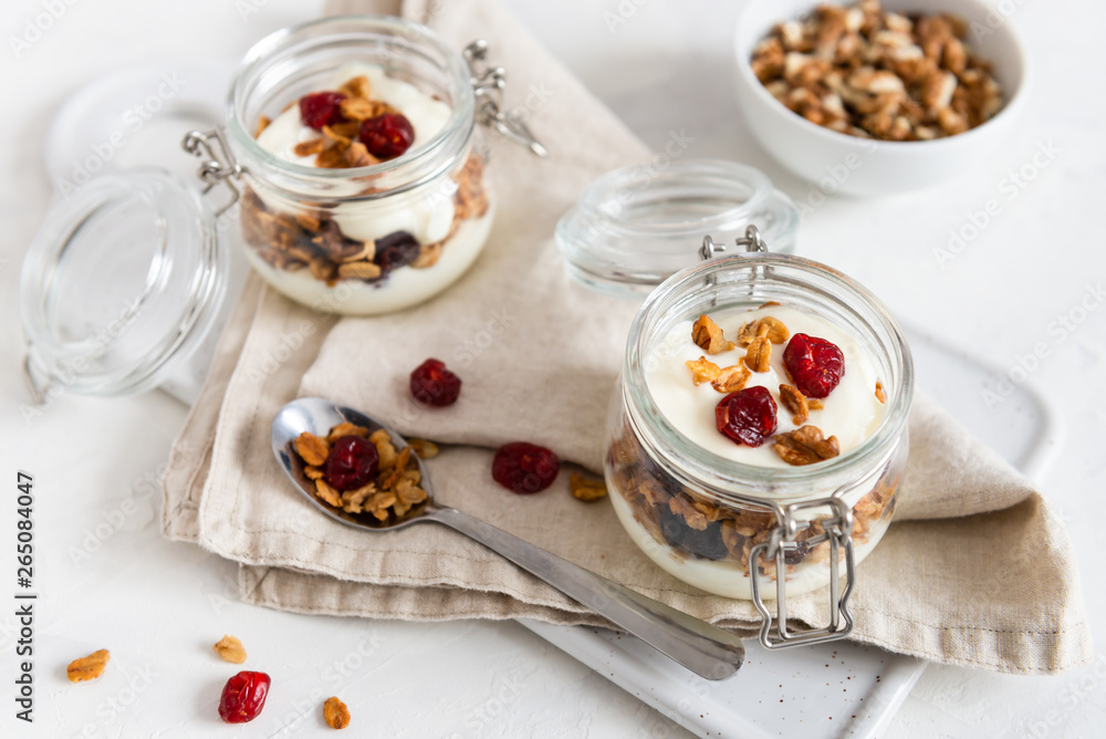 Dry breakfast cereals. Crunchy honey granola bowl with flax seeds, cranberries and yogurt. Healthy and fiber food. Breakfast time. Dieting. Close up Dry breakfast cereals. Crunchy honey granola bowl with flax seeds, cranberries and yogurt. Healthy and fiber food. Breakfast time. Dieting. Close up