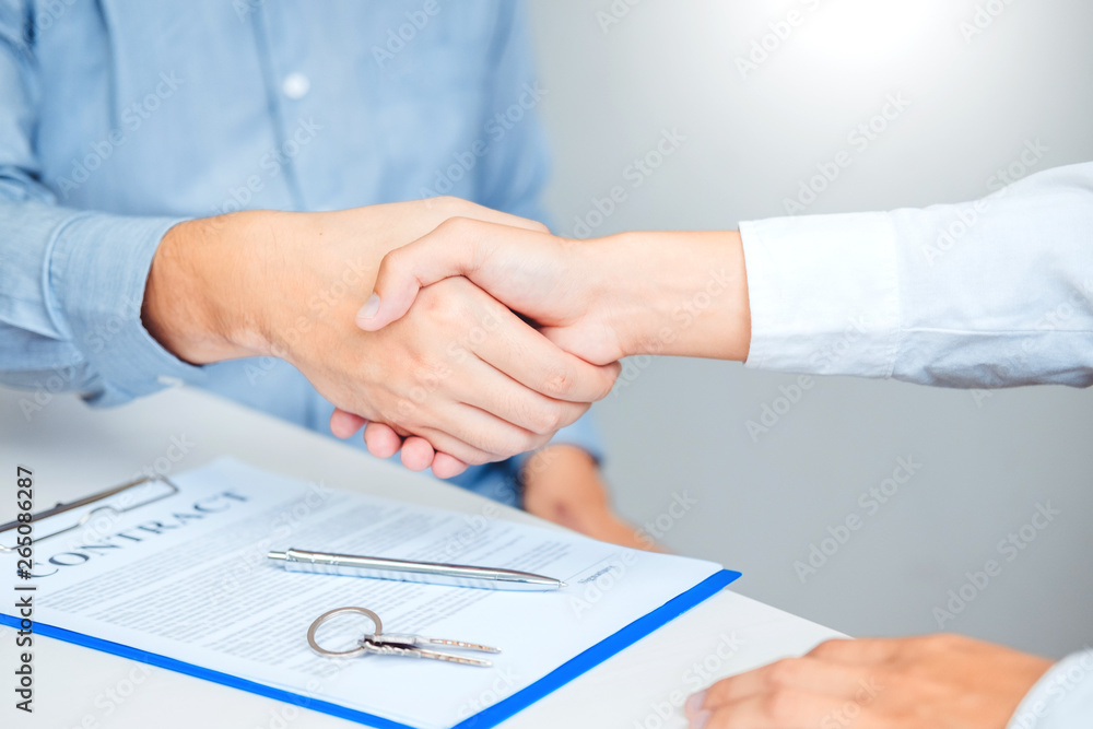 Sale agent and customer handshake and sign agreement contract, Insurance Home concept Sale agent and customer handshake and sign agreement contract, Insurance Home concept