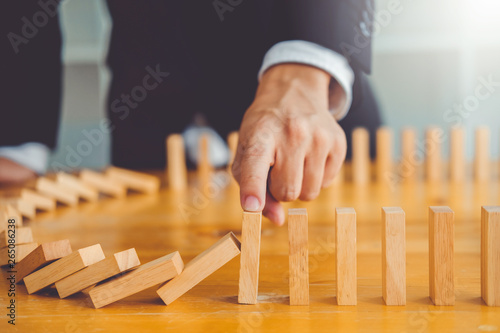 Businessman plan and strategy in business Domino Effect Problem Solving