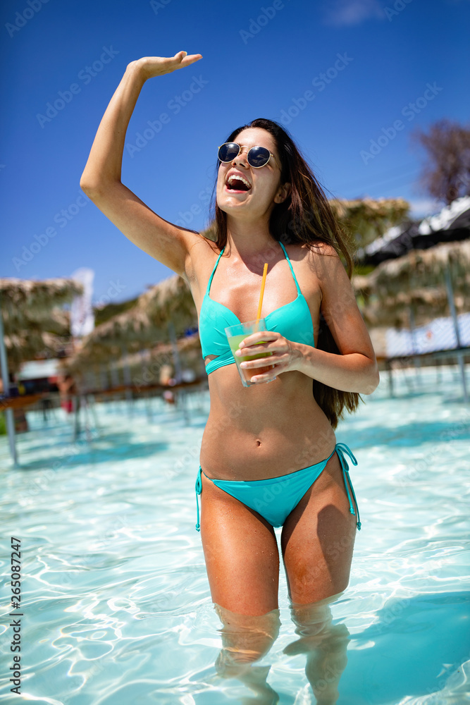 Sexy woman drinking cocktail in summer and enjoying party