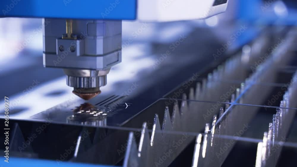The industrial laser cutting torch cuts preparations from metal. Clip. Laser cutter in the production. Industrial cnc plasma cutting of metal plate. Closeup. lot of bright sparks.
