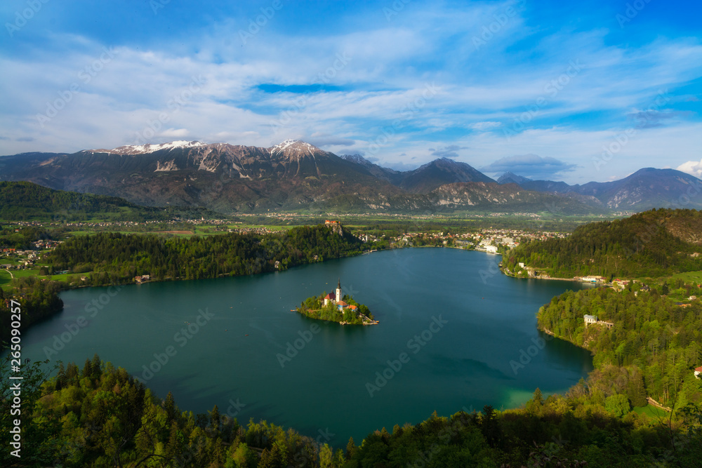 Landscape of Lake Bled region (Slovenia) from Mala Osojnica hill, on the lake the island with the church of the assumption of Maria, Julian Alps on the background