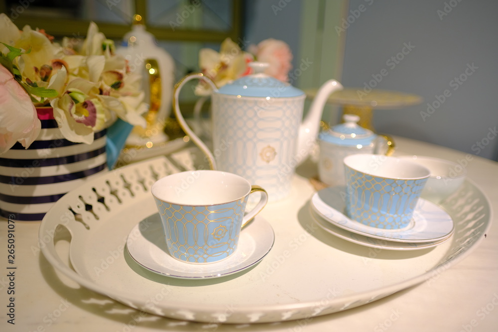 Teapot and tea cup and dishes flat lay setting on the table Teapot and tea cup and dishes flat lay setting on the table