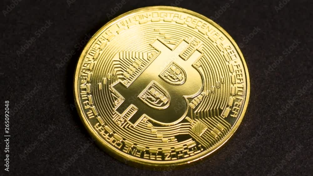 Bitcoin cryptocurrency rotating seamless loop. Golden crypto coin against black background, macro shot.
