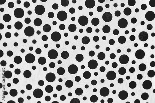 Chaotic texture of a white background with scratches and black circles of different diameters