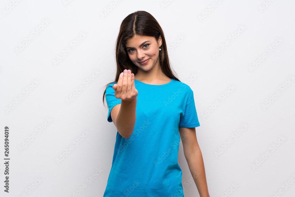 Teenager girl with blue shirt inviting to come with hand. Happy that you came Teenager girl with blue shirt inviting to come with hand. Happy that you came