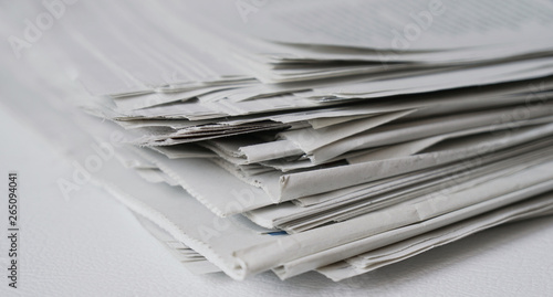 messy pile of newspapers or papers - news or paper recycling concept photo
