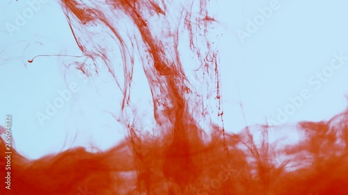 Slow abstract motion and diffusion of red paint in water