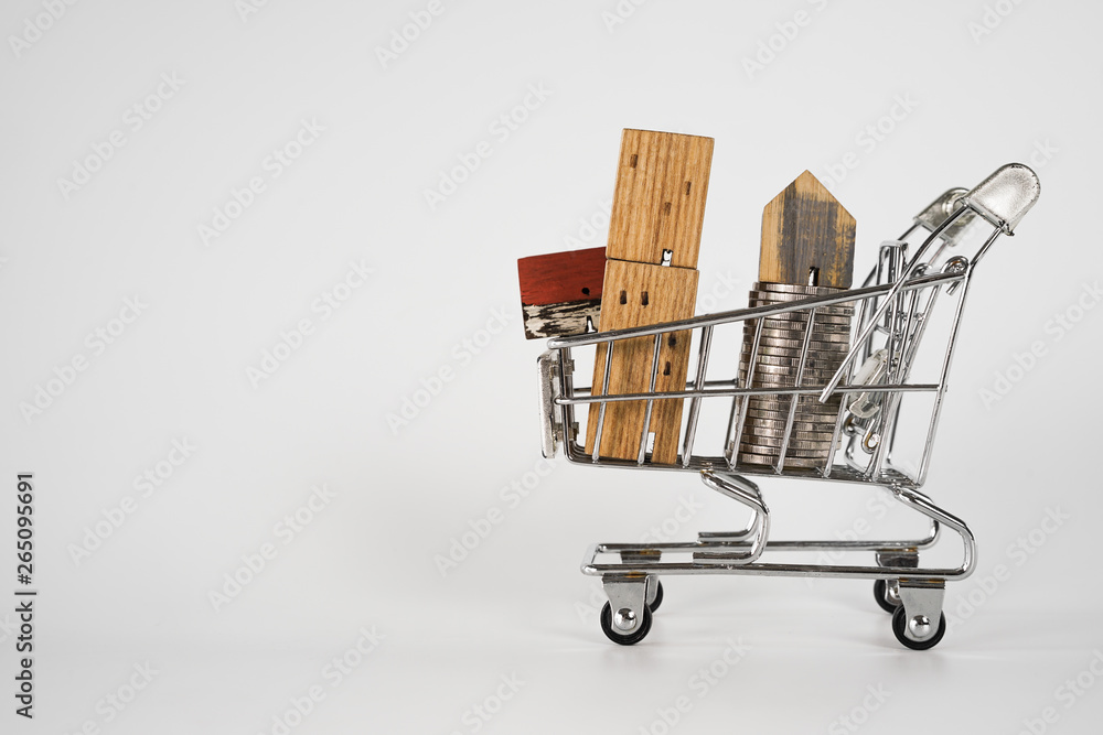 Wood house model in shopping cart on white background. Real Estate market, Trading Estate, Mortgage Concepts.