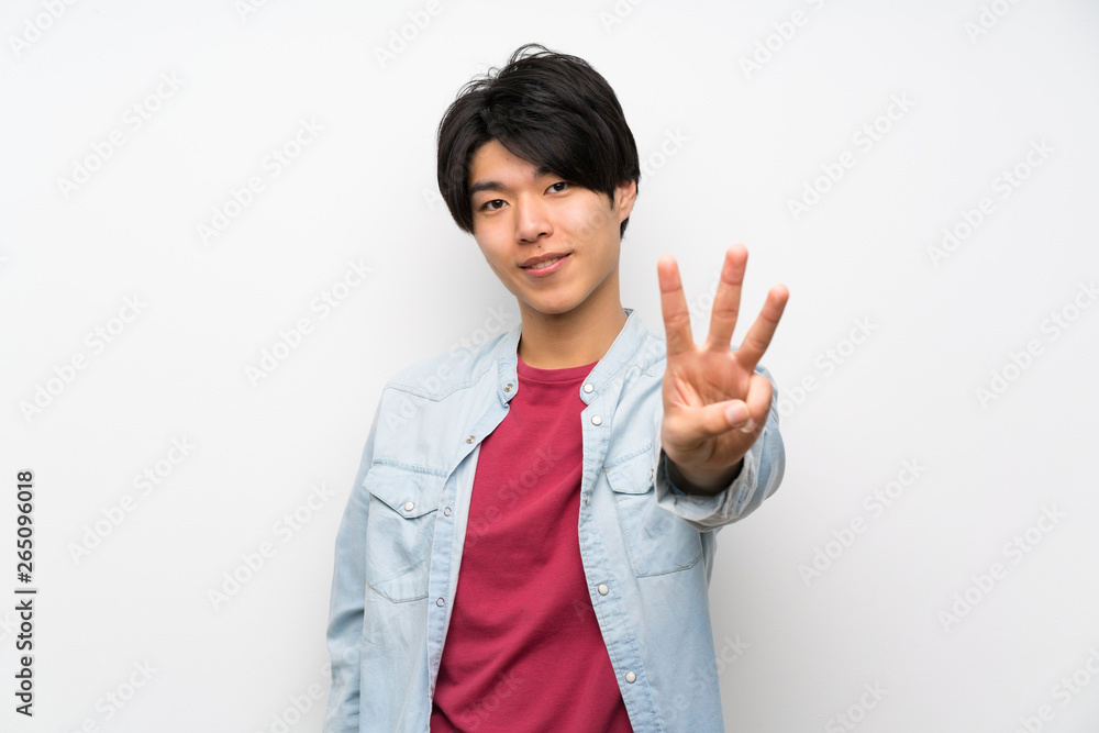 Asian man on isolated white background happy and counting three with fingers Asian man on isolated white background happy and counting three with fingers